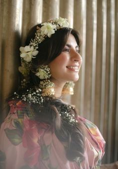 a woman with flowers in her hair smiling