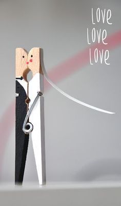 a pair of scissors cutting into a piece of paper with the words love love on it