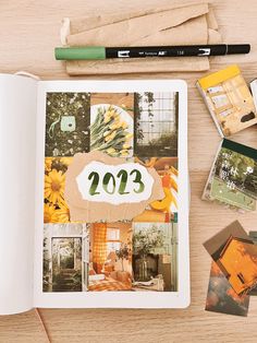 an open book on a table with pictures and pencils next to it that says 2012