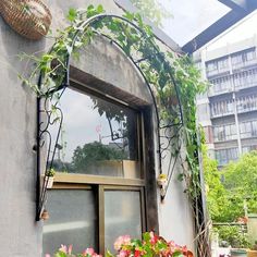 an open window on the side of a building with plants growing out of it's windowsill