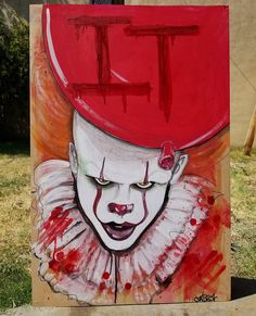 a painting of a clown with the letter t painted on it's face in red and white