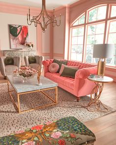 a living room filled with pink couches and chairs