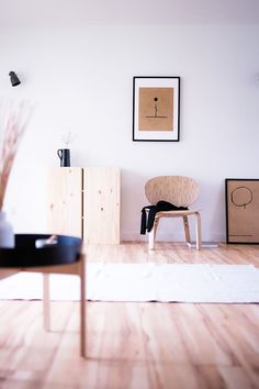 a living room with white walls and wooden floors