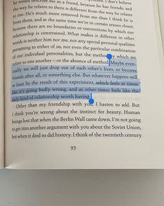 an open book with blue text on the page and two small circles in between it