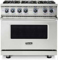 a stainless steel stove with four burners and two oven doors on each side, in front of a white background