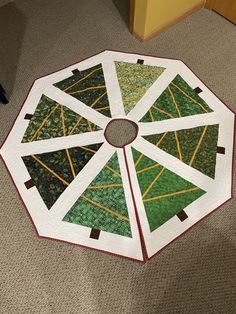 a quilted table topper sitting on the floor