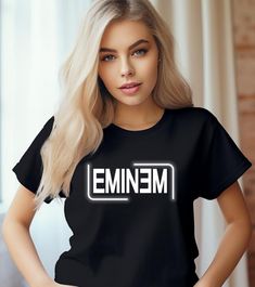 a woman wearing a t - shirt with the word emim printed in white on it