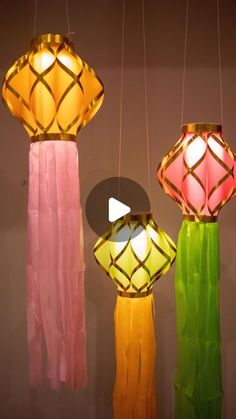 three different colored lamps hanging from strings