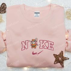 Nike x Angel Stitch Spooky Pumpkin Embroidered Sweatshirt, Custom Nike Embroidered Hoodie, Best Gifts for Family Welcome to the enchanting world of Tinicloset, where fashion takes on a delightful twist of creativity and whimsy. Step into a realm where your wardrobe becomes a canvas for imagination, and where every garment tells a story that is... Pink Winter Sweatshirt With Embroidered Graphics, Winter Pink Sweatshirt With Embroidered Graphics, Pink Embroidered Hoodie For Fall, Pink Hoodie With Embroidered Text For Winter, Cute Hooded Tops With Embroidered Logo, Cute Hooded Top With Embroidered Logo, Winter Pink Hoodie With Embroidered Text, Pink Long Sleeve Hoodie With Embroidered Text, Cute Hooded Sweatshirt With Custom Embroidery