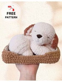 a hand holding a white stuffed dog in a basket with the text free pattern on it