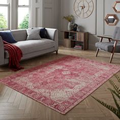 a living room filled with furniture and a red rug