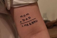 a woman with a tattoo on her arm that says mom and dad me & bro