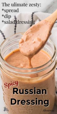 a spoon full of russian dressing on top of a jar with the words spicy russian dressing above it