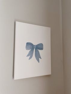 a white wall with a blue bow on it