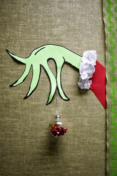 an ornament hanging from the side of a piece of fabric with paper on it