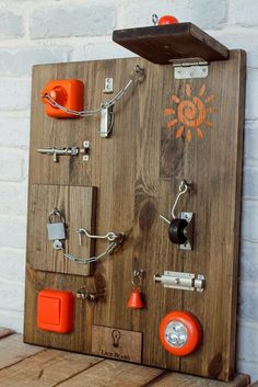 a wooden board with many different types of items attached to it and an orange light on top