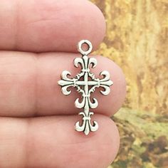 You will receive BULK 30 - Fleur de Lis Cross Charms in Antique Silver Pewter! These charms are a quality Silver Pewter for all your jewelry and crafting projects! - (30) Small Silver Cross Charm - 23x14mm ( 25.4mm = 1 inch ) - Quality Pewter - Item # SP0044B Cross Charms in Bulk All Items will come as shown in a poly bag! WE ARE LOCATED IN TEXAS. WHICH MEANS YOU RECEIVE ITEMS QUICKLY IF IN THE U.S! WE ALSO SHIP INTERNATIONALLY All items are shipped after payment is received for your convenience Wedding Accessories Jewelry, Small Crosses, Cross Charms, Silver Cross, Houston Tx, Cross Pendant, Wedding Accessories, Belly Button Rings, Antique Silver