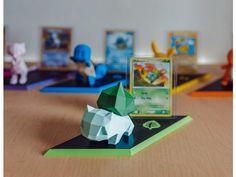 an origami animal is sitting on top of a table next to some cards