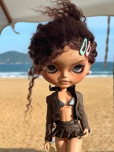 a close up of a doll on a beach