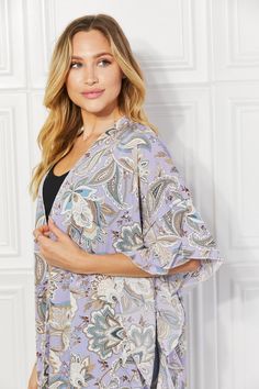 A captivating addition to your wardrobe that combines elegance and flair. This kimono is designed to enhance your style with its graceful silhouette, delicate floral patterns, and charming ruffle accents. This kimono features a lightweight and breathable fabric that drapes beautifully, creating a flowing and ethereal look. The floral motifs, carefully chosen and artfully arranged, add a touch of femininity and sophistication to thegeneral design. The standout feature of this kimono is its side ruffle detail, which adds a playful and romantic touch. The ruffles cascade down the sides, creating movement and enhancing the visual appeal of the garment. Pattern type: Floral Style: Outdoors, Chic Features: Ruffle Neckline: Open front Length: Long Sleeve length: Half sleeves Sleeve type: Dolman s Elegant V-neck Kimono For Spring, Spring Feminine Robe With Kimono Sleeves, Flowy Wrap Robe For Spring, Elegant Open Front Kimono For Spring, Elegant Spring Vacation Robe, Summer Feminine Floral Print Kimono, Feminine Floral Print Summer Kimono, Chic Floral Print Kimono For Daywear, Elegant Spring Kimono With Kimono Sleeves