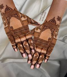 two hands with henna designs on them