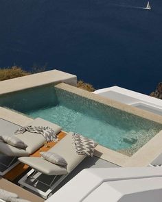 an outdoor hot tub next to the ocean