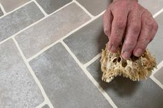 a person is cleaning the floor with a sponge