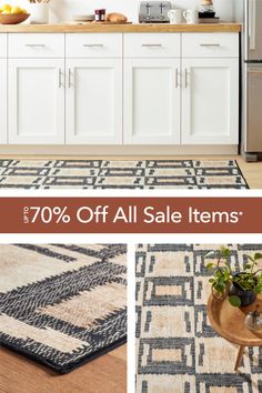 a kitchen with white cabinets and an area rug