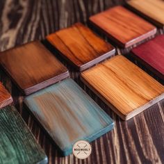 the wooden coasters are lined up on the table with different colored woodgrains