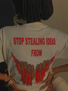 the back of a woman's shirt that says stop stealing ideas from