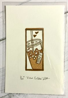 An image of a small two-layered relief print depicting an iced coffee in two shades of brown. the print is made by hand from a carved eraser and is numbered, titled and signed. Eraser Prints, Carved Stamps, Creativity Exercises