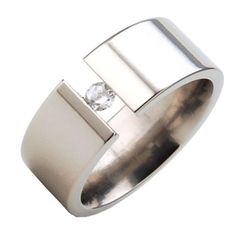 MADE IN THE USA comfort fit band that is custom made to order with Aerospace Grade Titanium! Using our state of the art manufacturing facility, this 8 mm band features a beautiful 3 mm White Sapphire. An all Polish finish gives this ring the perfect finishing touch. The quality of this ring is unmatched! **PLEASE NOTE** The gemstone is thick, and it is possible, if the ring is snug, you will feel it on your finger. Because of this, we recommend sizing your ring a quarter size larger** SKU# 8FP-T Modern Wide Band Wedding Ring With Round Cut, Modern Rings With Thick Band And Tension Setting, Modern Wide Band Ring With Tension Setting For Anniversary, Modern Thick Band Diamond Ring As Gift, Modern Wide Band Ring With Tension Setting, Modern Thick Band Promise Ring, Modern Wide Band Promise Ring, Modern Wide Band Promise Diamond Ring, Modern Diamond Ring With Thick Band