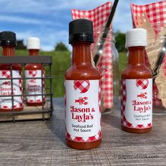 three bottles of seasoning and layja's hot sauce on a picnic table