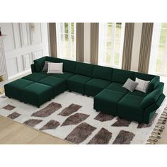 a large green sectional couch sitting on top of a white and brown rug in a living room