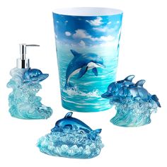 three pieces of bathroom accessories including a dolphin and dolphins in the ocean with blue waves