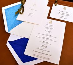 the wedding stationery is laid out on top of each other