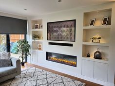 a living room with a fireplace and built in shelves