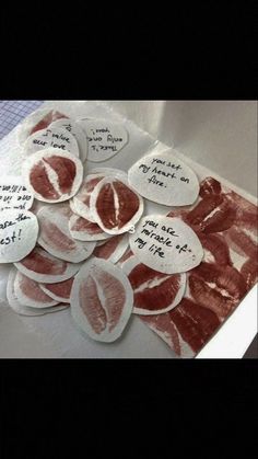 several pieces of paper with writing on them and some slices of meat in the middle