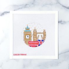 a cross - stitch card with the london skyline and big ben in england on it