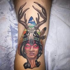 a woman with an antelope head tattoo on her leg