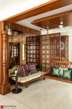 a living room filled with furniture and lots of wood paneled walls on top of it