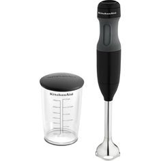 a kitchen aid blender next to a measuring cup