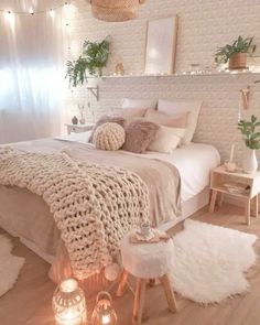 a bedroom with white walls and wooden flooring is decorated in neutral tones, such as beige