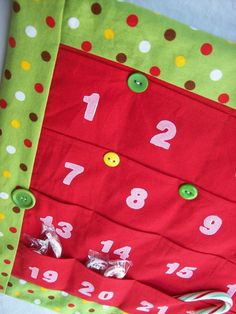 a close up of a red and green cloth with white numbers on it, surrounded by candy