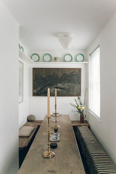 a long wooden table with candles on it