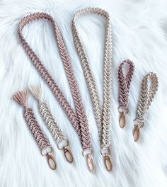 four different types of leashes laying on top of a white furnishing area