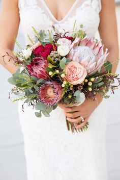 a bride holding a bouquet of flowers in her hands