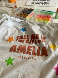 a white t - shirt with the words call me someone amella written on it