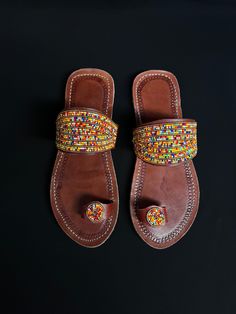 Unique Africa Maasai Handcrafted Beaded Leather Sandals with an Elegant Look and Brilliant Finish. Color =Multi Color. Size = Optional. **GET FREE SHIPPING FOR ADDITIONAL ITEMS PURCHASED. Yes, Buy Multiple Items and pay shipping for 1 item only- The rest ships Free. (No Limits on the number of Multiple items). With a faster delivery time of 3 days via DHLExpress, Worldwide. Ordinary/Standard Shipping also available upon request. We Custom Make to Suit Your Taste. Available In All Colors and Size Traditional Brown Toe Post Flip Flops, Handmade Brown Toe Loop Flip Flops, Traditional Slip-on Toe Ring Sandals For Beach, Handmade Brown Toe Ring Sandals, Handmade Closed Toe Brown Flip Flops, Traditional Brown Open Toe Barefoot Sandals, Traditional Handmade Brown Flip Flops, Handmade Adjustable Slip-on Sandals, Traditional Closed Toe Barefoot Sandals For Vacation