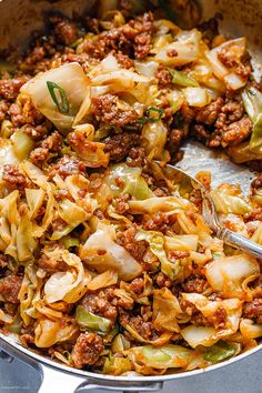 a skillet filled with pasta and meat